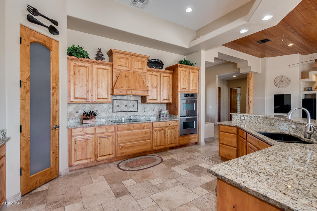 1982 North Goldfield Road Apache Junction, AZ 85119 - Photo 18 of 86 a large kitchen with stainless steel appliances granite countertop a stove and a sink