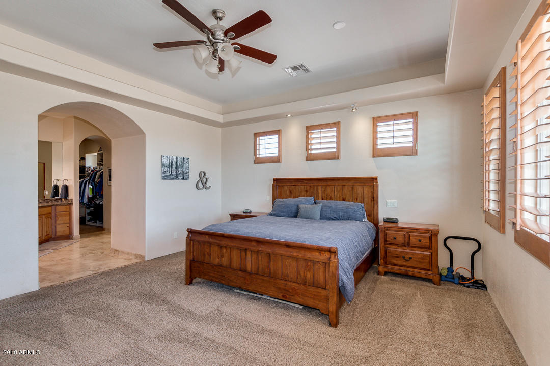 1982 North Goldfield Road Apache Junction, AZ 85119 - Photo 22 of 86 a spacious bedroom with a bed and a table