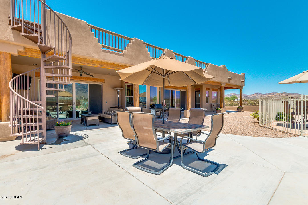 1982 North Goldfield Road Apache Junction, AZ 85119 - Photo 42 of 86 a view of a patio with a table and chairs under an umbrella