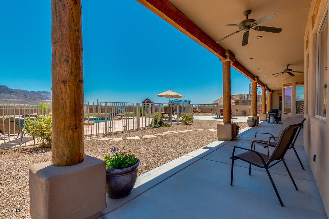 1982 North Goldfield Road Apache Junction, AZ 85119 - Photo 48 of 86 a swimming pool with outdoor seating and plants