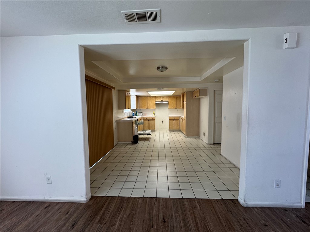 3822 1/2 Grace Avenue Baldwin Park, CA 91706 - Photo 5 of 8 a view of a kitchen with furniture and wooden floor