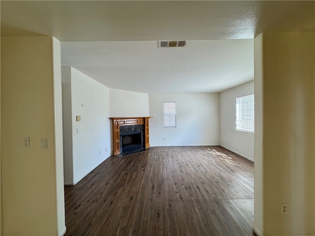 3822 1/2 Grace Avenue Baldwin Park, CA 91706 - Photo 6 of 8 a view of empty room with wooden floor and fireplace