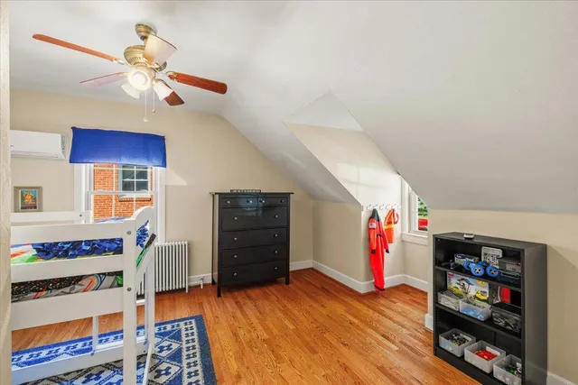 a bedroom with furniture and a book shelf