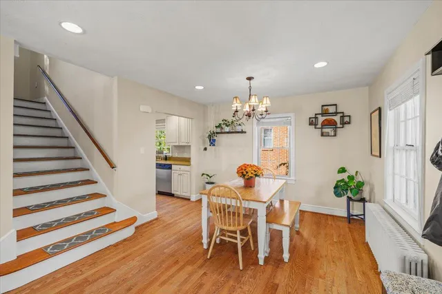 a dining room with furniture entryway and wooden floor