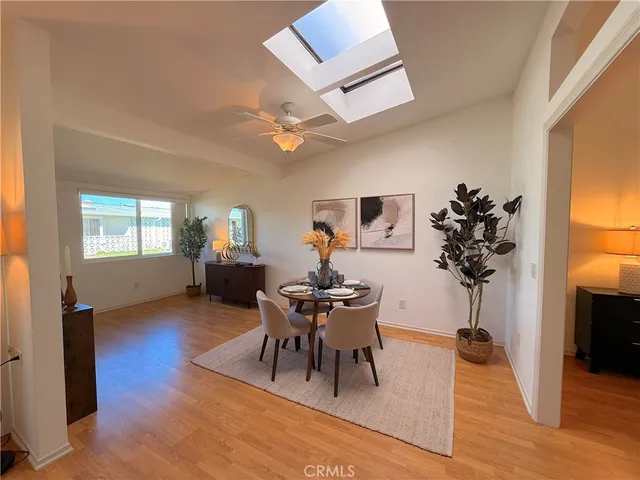 a living room with furniture a potted plant and a chandelier