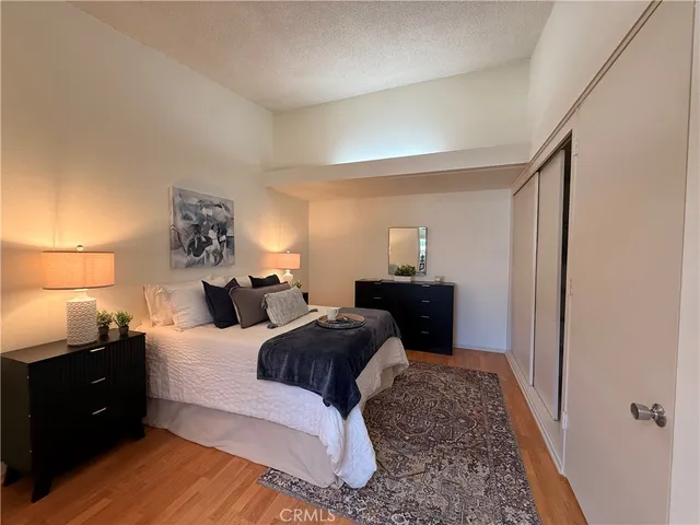 a bedroom with a bed and a lamp