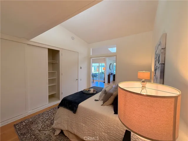 a bedroom with a sink and a mirror