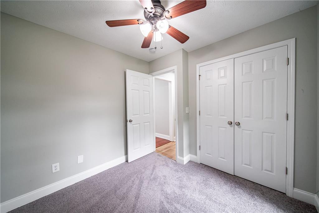 1927 Lee Road Salem, AL 36874 - Photo 40 of 45 Unfurnished bedroom with carpet floors, ceiling fan, and a closet