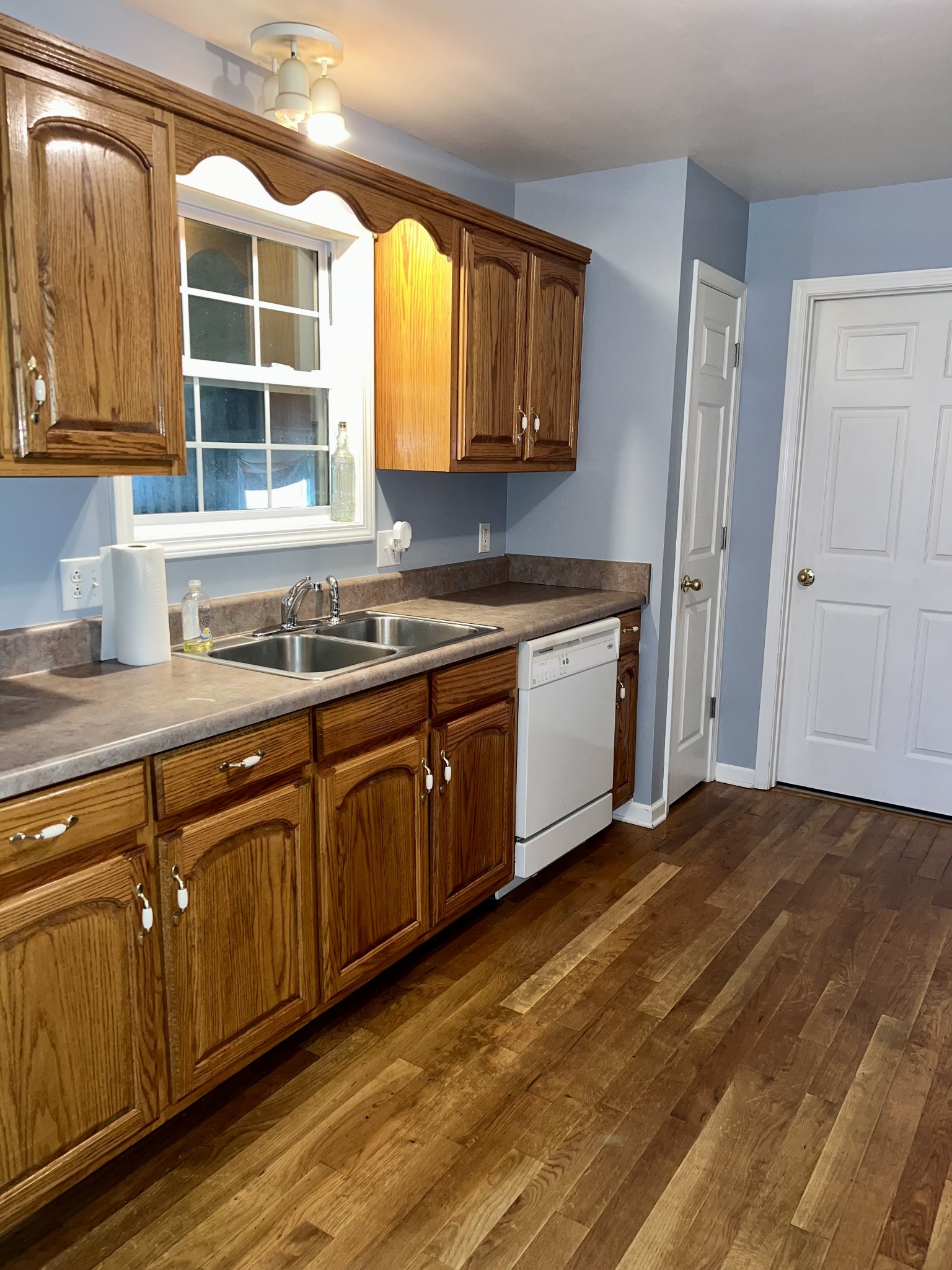 12480 Owens Chapel Road Springfield, TN 37172 - Photo 7 of 36 a kitchen with stainless steel appliances granite countertop a sink and cabinets with wooden floor