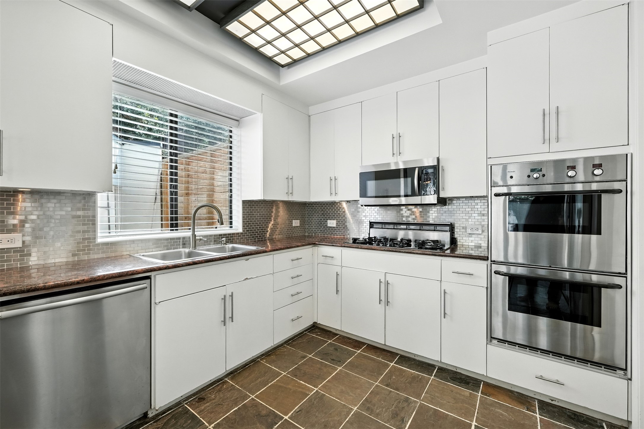 2019 McClendon Street Houston, TX 77030 - Photo 15 of 45 a kitchen with stainless steel appliances granite countertop a stove a sink and a microwave