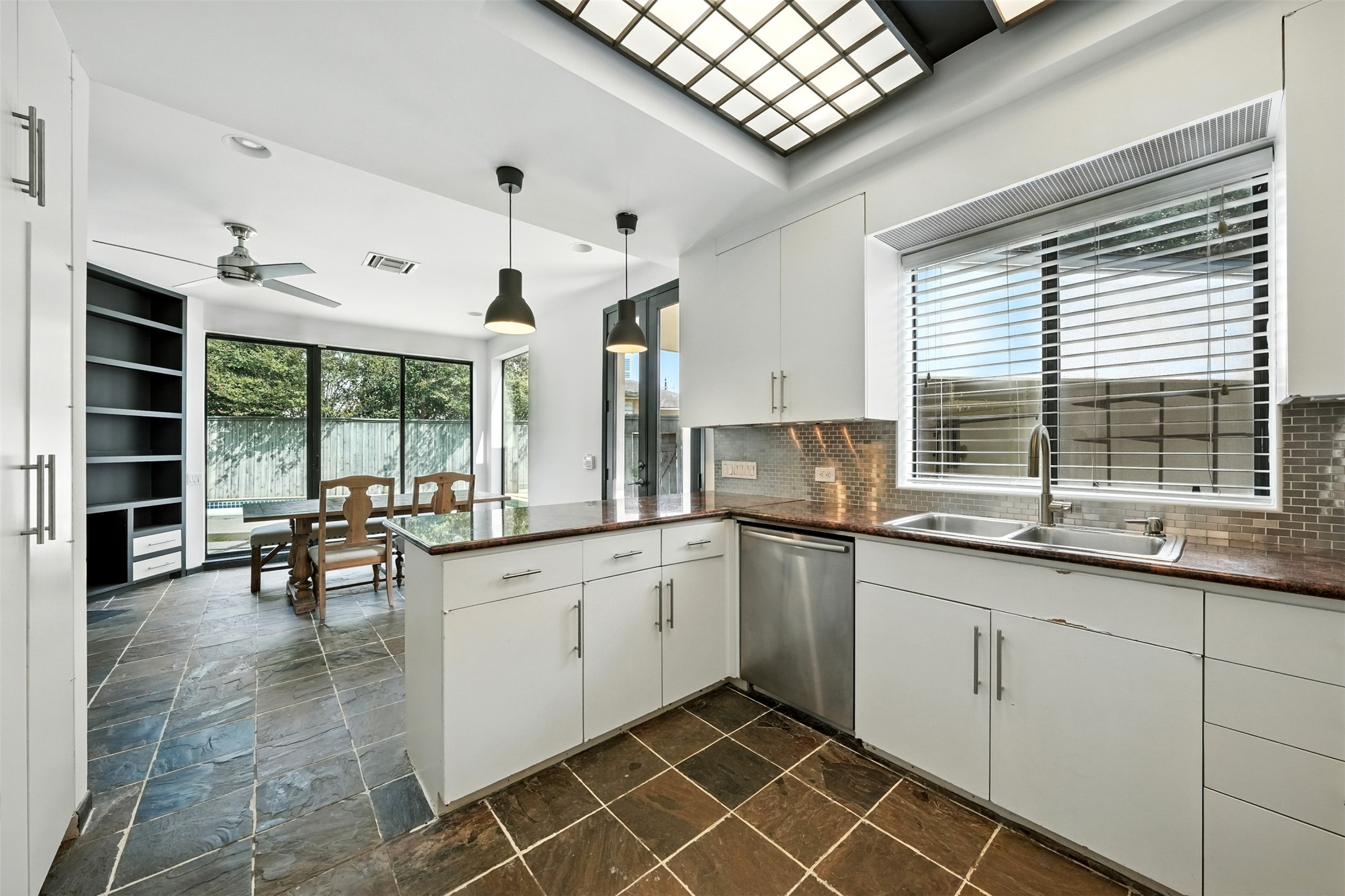 2019 McClendon Street Houston, TX 77030 - Photo 16 of 45 a kitchen with granite countertop a sink and white cabinets