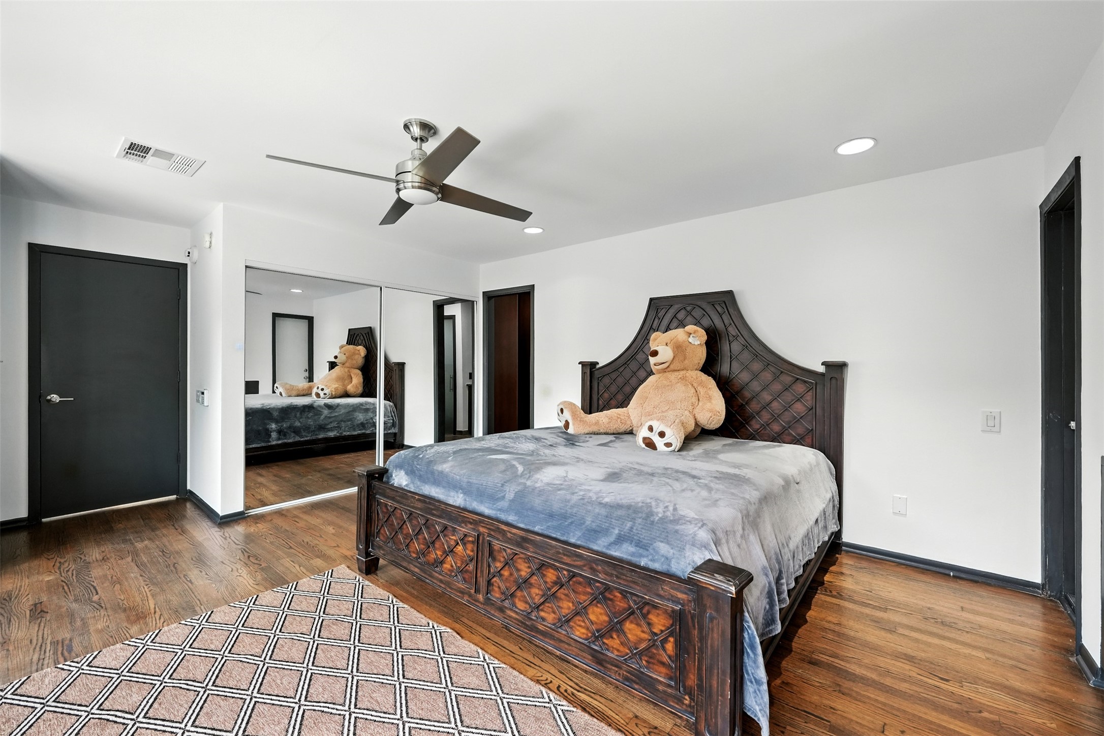 2019 McClendon Street Houston, TX 77030 - Photo 21 of 45 a spacious bedroom with a bed and dresser