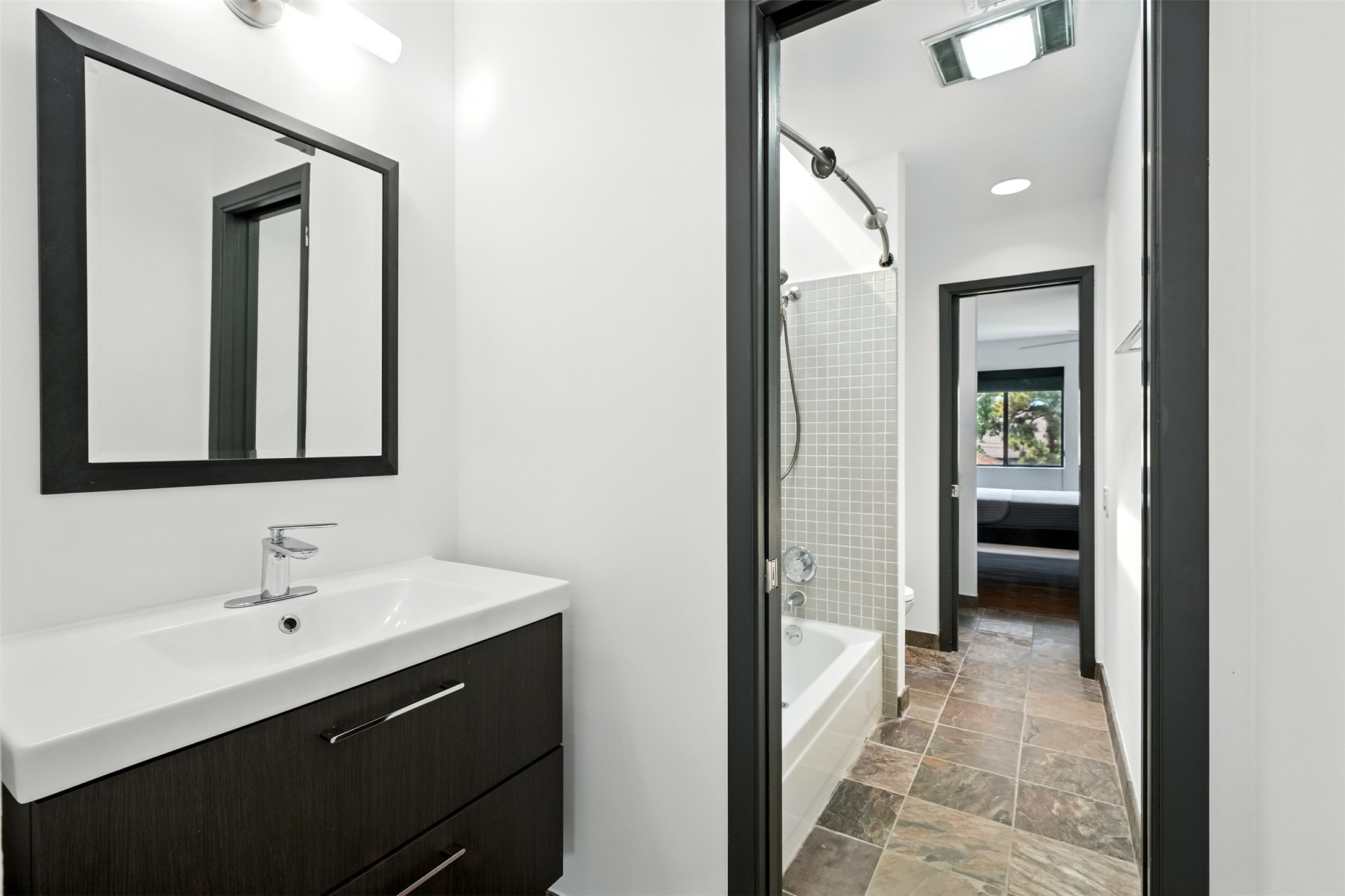 2019 McClendon Street Houston, TX 77030 - Photo 29 of 45 a bathroom with a sink and a mirror
