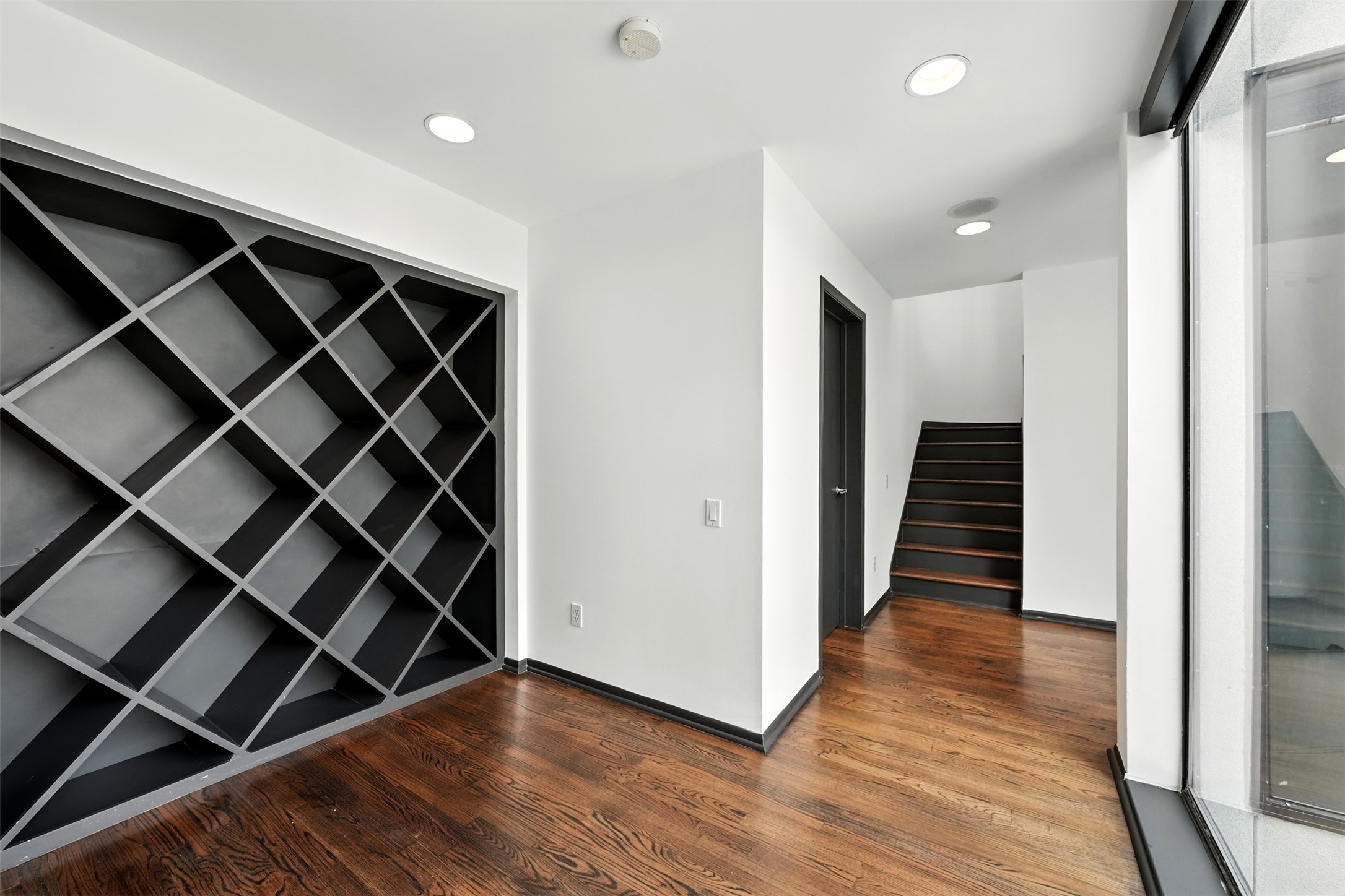 2019 McClendon Street Houston, TX 77030 - Photo 31 of 45 a view of an empty room with wooden floor and stairs