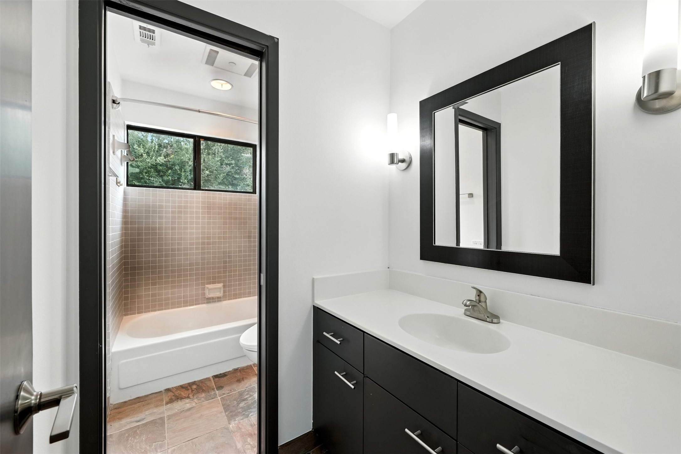 2019 McClendon Street Houston, TX 77030 - Photo 33 of 45 a bathroom with a sink and a mirror