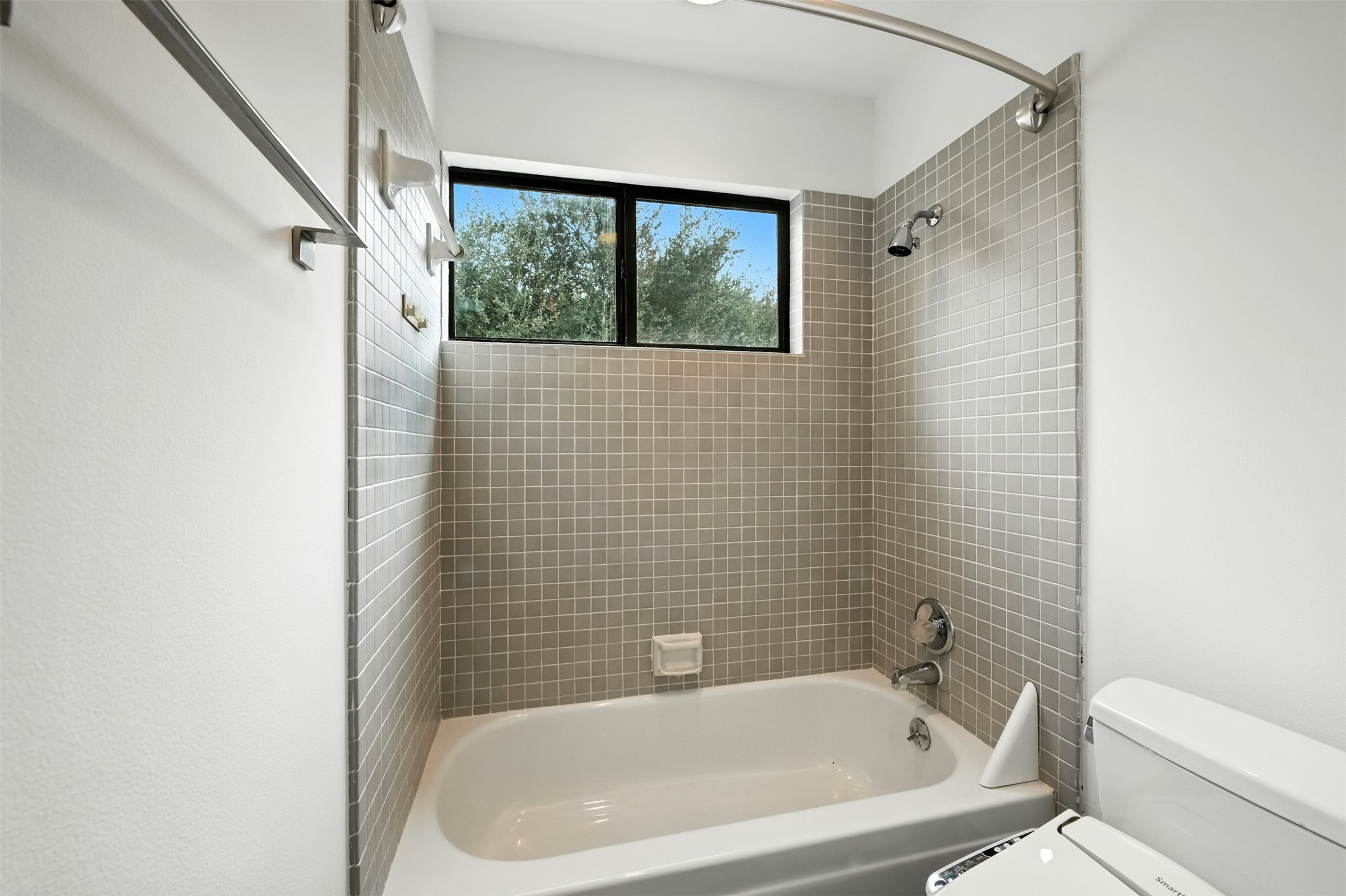 2019 McClendon Street Houston, TX 77030 - Photo 34 of 45 a bathroom with a bathtub and window