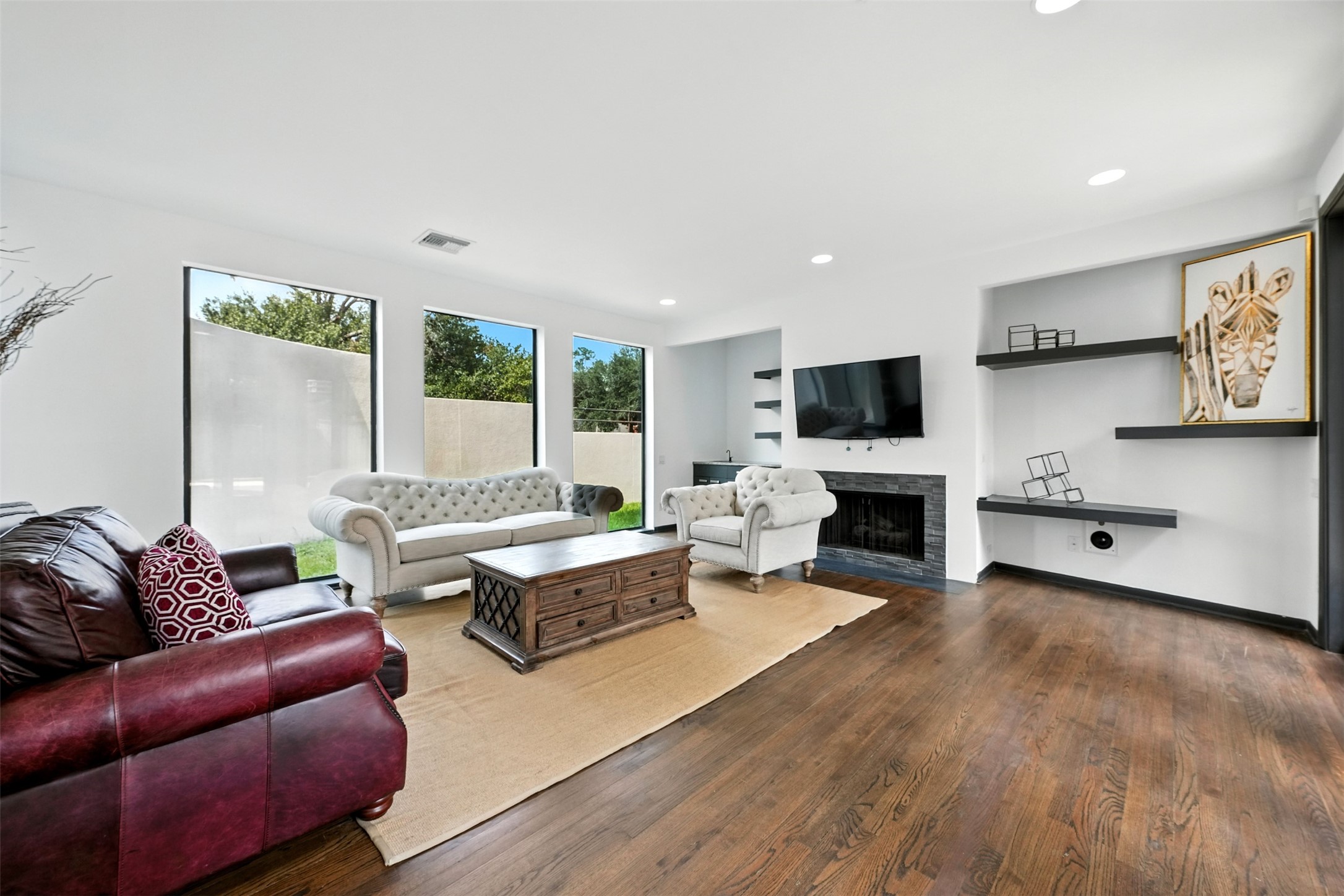 2019 McClendon Street Houston, TX 77030 - Photo 5 of 45 a living room with furniture flat screen tv and a fireplace