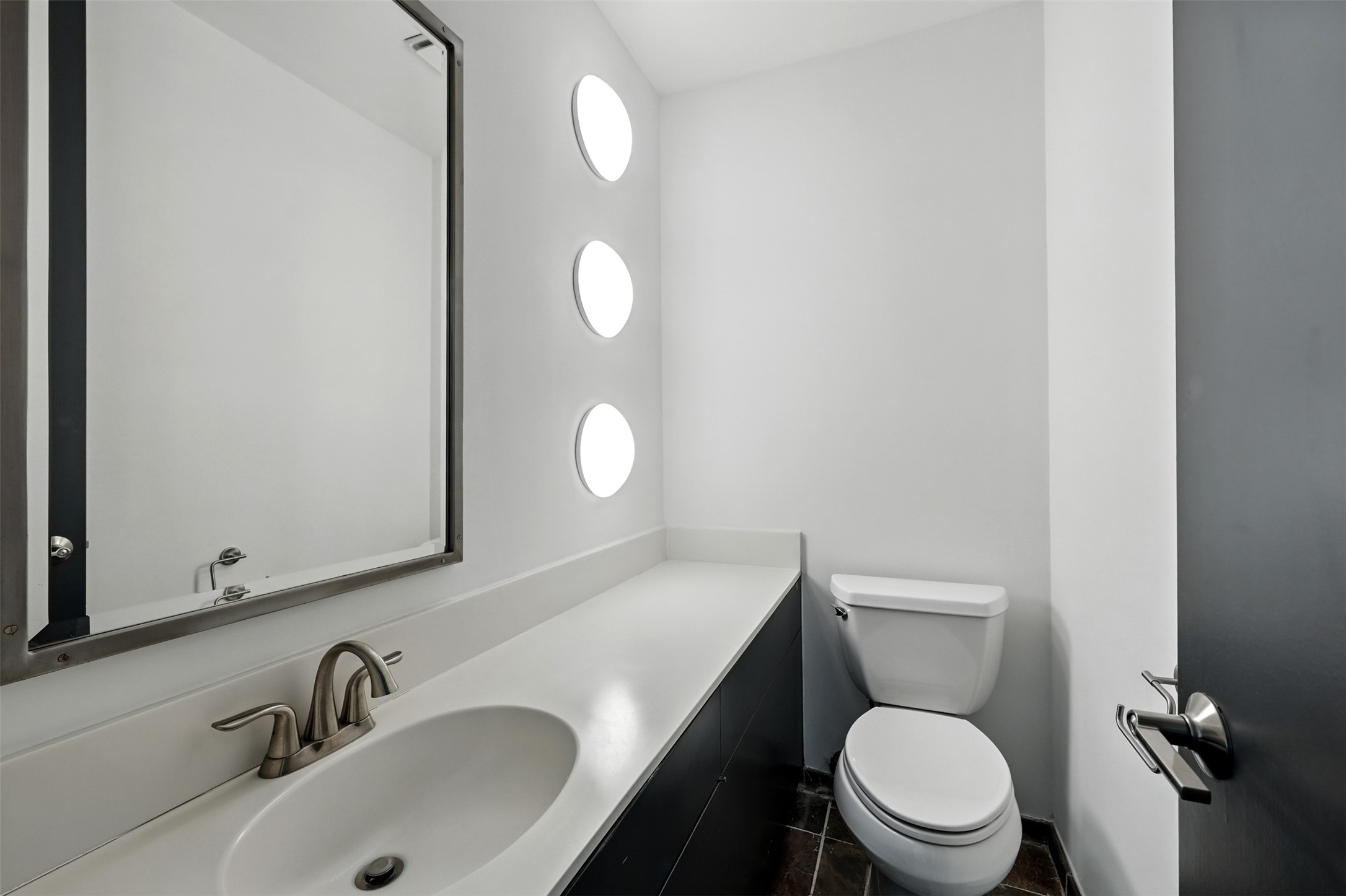 2019 McClendon Street Houston, TX 77030 - Photo 9 of 45 a white toilet sitting next to a bathroom sink