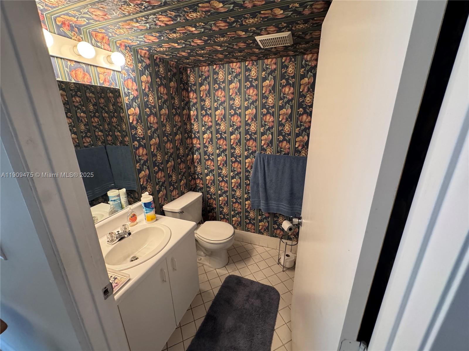 1650 Southwest 124th Terrace, Unit 403D Pembroke Pines, FL 33027 - Photo 2 of 11 a bathroom with a toilet and a shower curtain