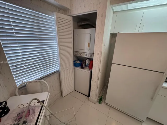 a view of a kitchen with refrigerator and cabinet
