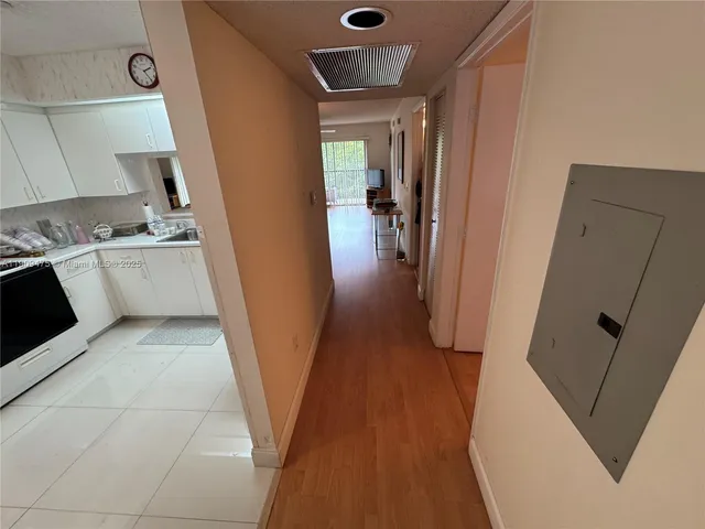 a kitchen with a sink and wooden floor