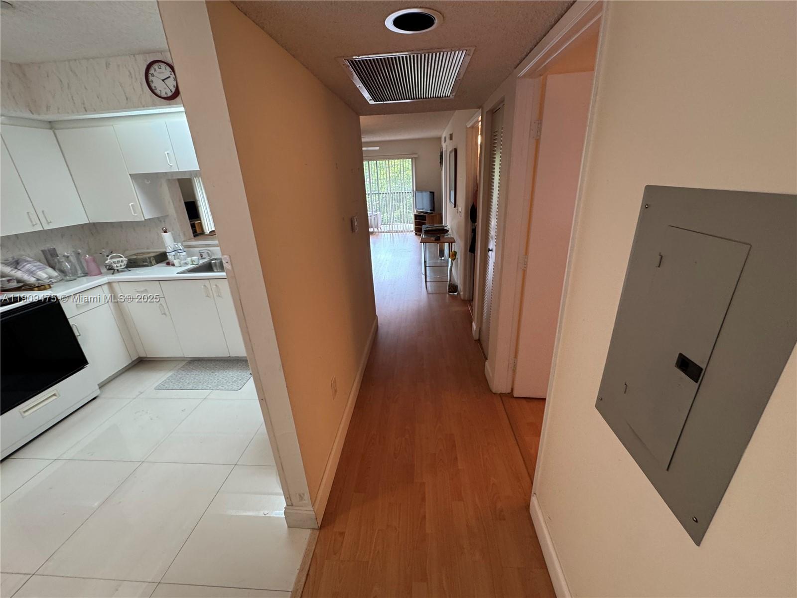 1650 Southwest 124th Terrace, Unit 403D Pembroke Pines, FL 33027 - Photo 5 of 11 a kitchen with a sink and wooden floor