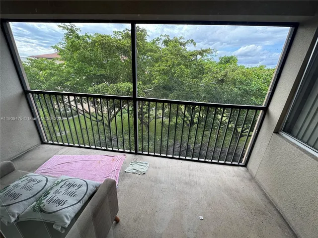 a bedroom with a bed a mirror on dresser and a chandelier