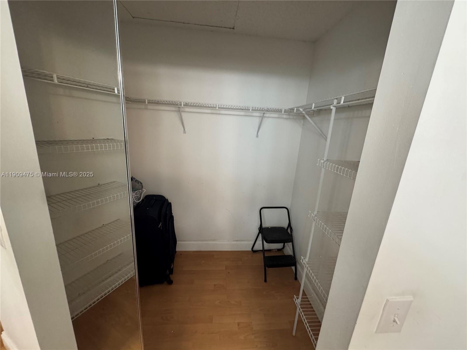 1650 Southwest 124th Terrace, Unit 403D Pembroke Pines, FL 33027 - Photo 9 of 11 a view of walk in closet with clothes and white walls