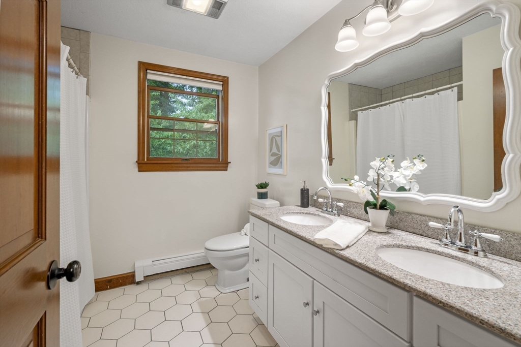 5 Ledgewood Road Saugus, MA 01906 - Photo 37 of 42 a bathroom with a granite countertop sink mirror vanity and toilet
