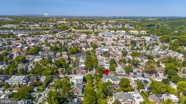 an aerial view of residential houses with city view