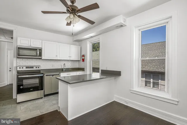 a kitchen with stainless steel appliances granite countertop a stove and a sink
