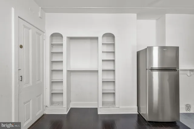 a view of walk in closet with empty racks