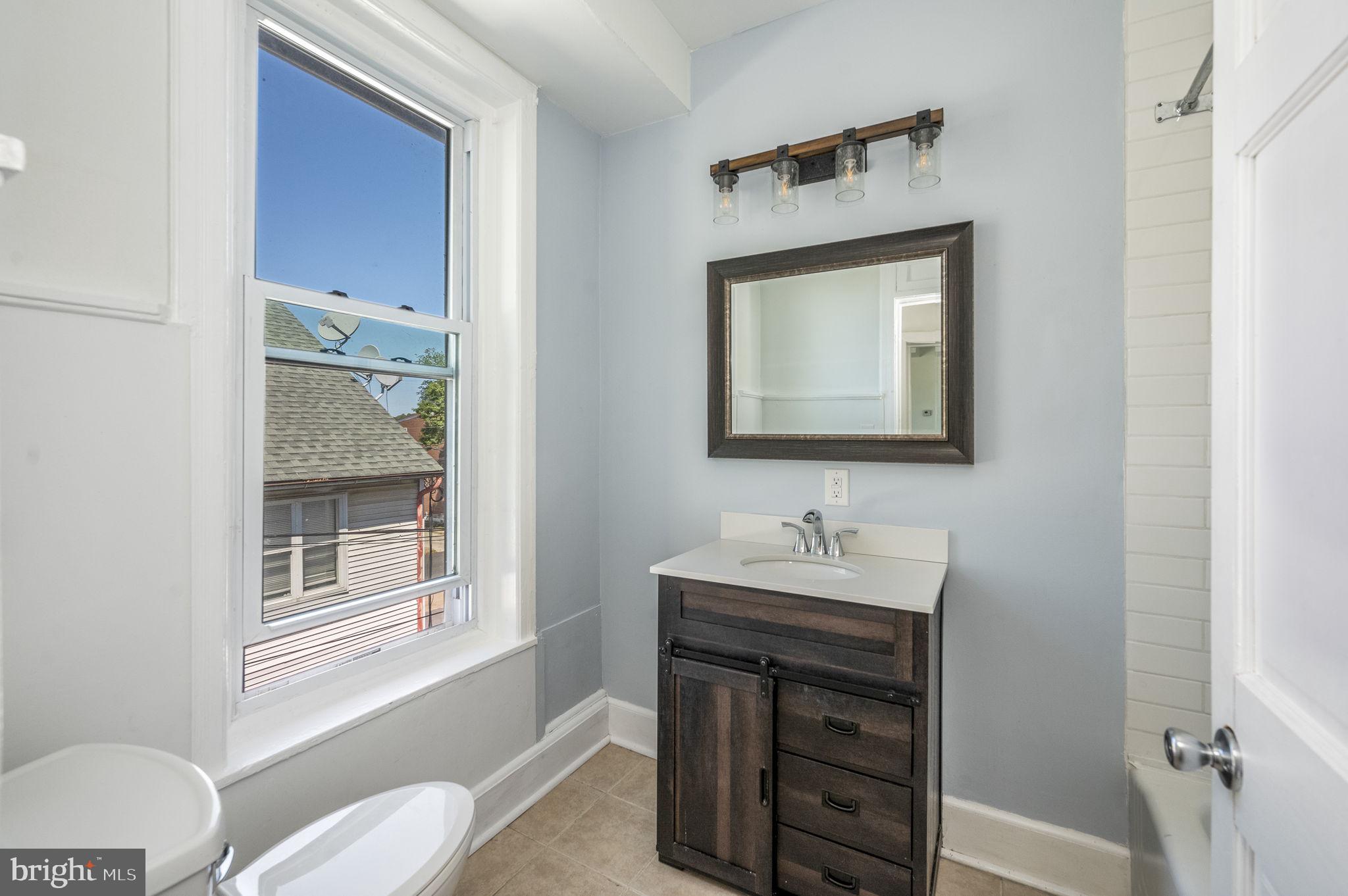 303 South Main Street, Unit 2 Phoenixville, PA 19460 - Photo 10 of 24 a bathroom with a sink and a mirror