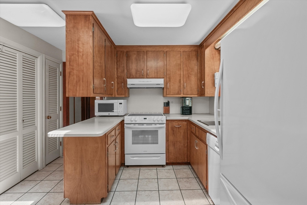 40 Ballardvale Road Andover, MA 01810 - Photo 11 of 36 a kitchen with a stove top oven sink and cabinets