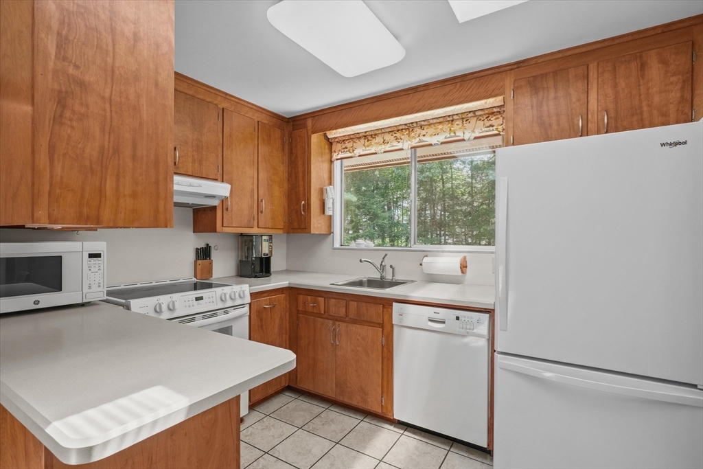 40 Ballardvale Road Andover, MA 01810 - Photo 12 of 36 a kitchen with a sink a stove and white cabinets