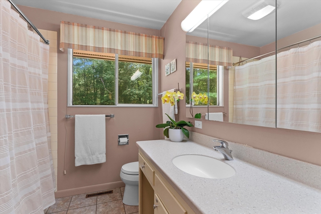 40 Ballardvale Road Andover, MA 01810 - Photo 17 of 36 a bathroom with a granite countertop sink toilet and mirror