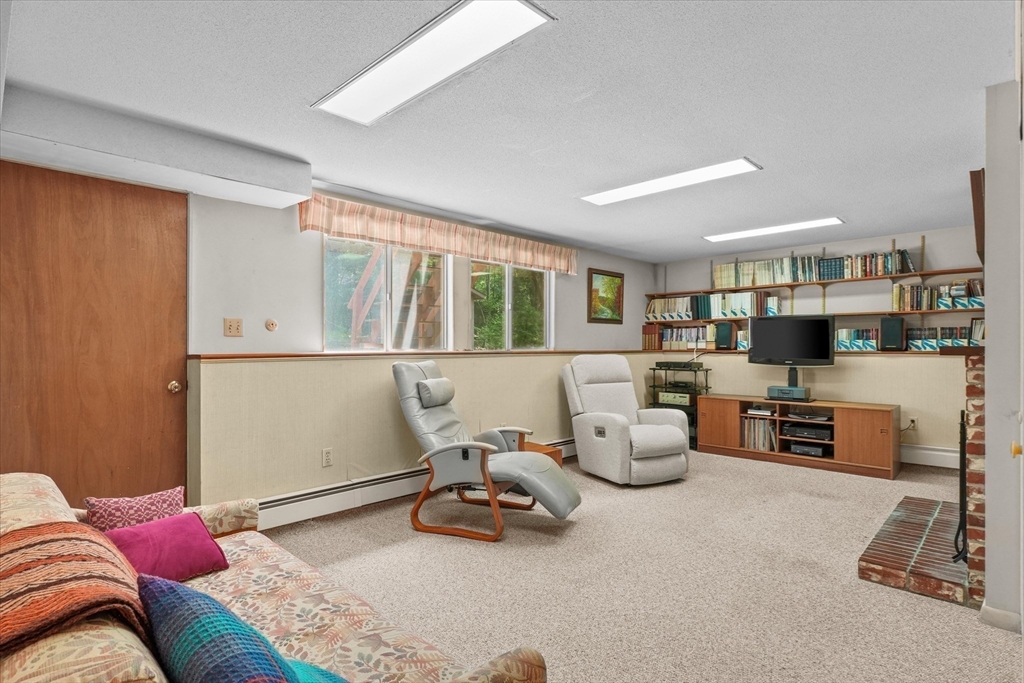 40 Ballardvale Road Andover, MA 01810 - Photo 18 of 36 a bedroom with furniture and a flat screen tv