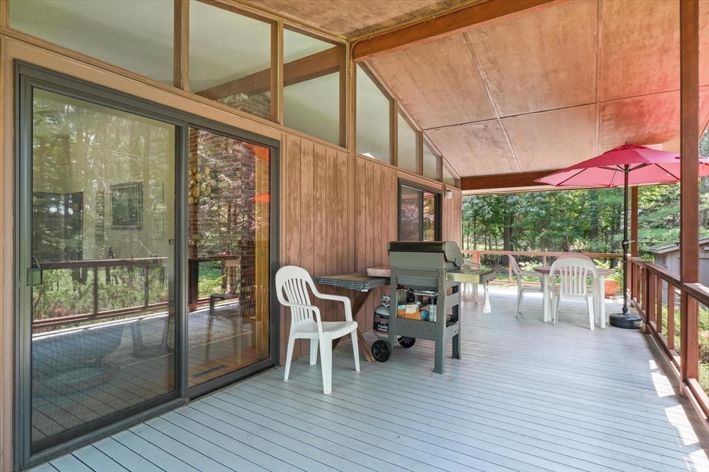 40 Ballardvale Road Andover, MA 01810 - Photo 25 of 36 a view of a patio with a dining table and chairs