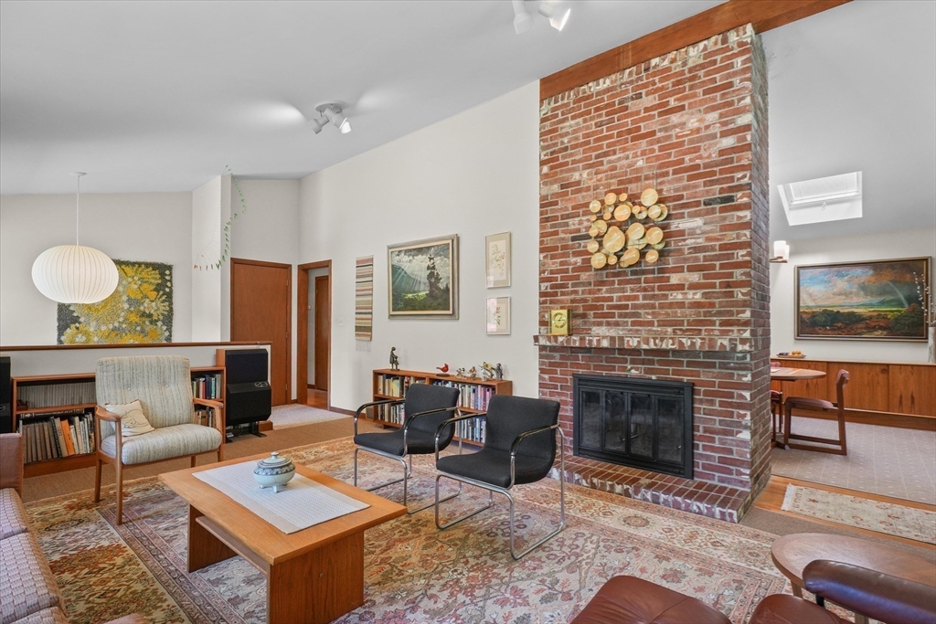 40 Ballardvale Road Andover, MA 01810 - Photo 8 of 36 a living room with fireplace furniture and a floor to ceiling window