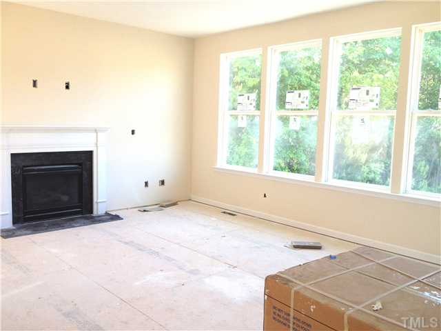 1104 Farmers Branch Road Willow Spring, NC 27592 - Photo 4 of 16 a room with a bed and a fireplace