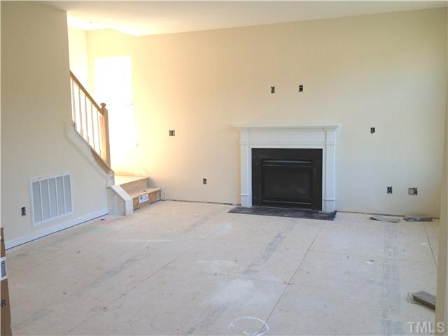 1104 Farmers Branch Road Willow Spring, NC 27592 - Photo 5 of 16 a view of an empty room with a fireplace
