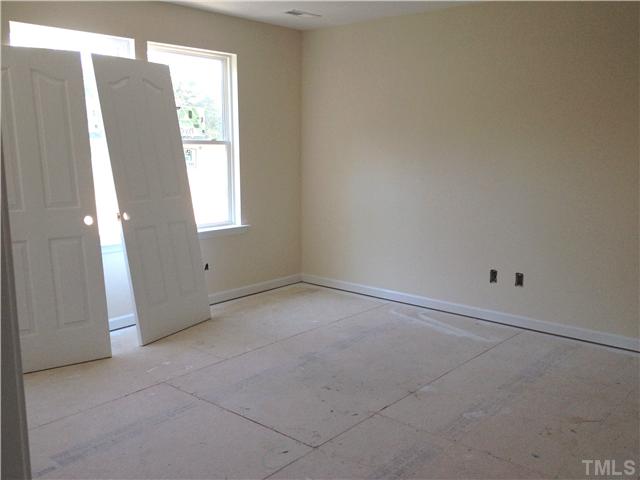 1104 Farmers Branch Road Willow Spring, NC 27592 - Photo 6 of 16 an empty room with windows and closet