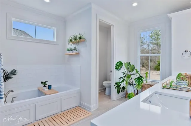 a white bath tub sitting next to a window