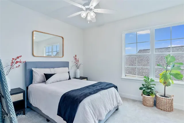 a bedroom with a bed and a potted plant