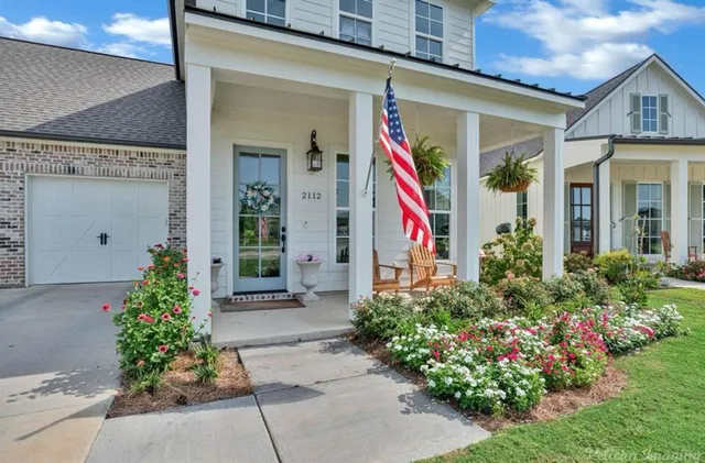 a front view of a house with plants