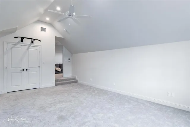 an empty room with closet and windows