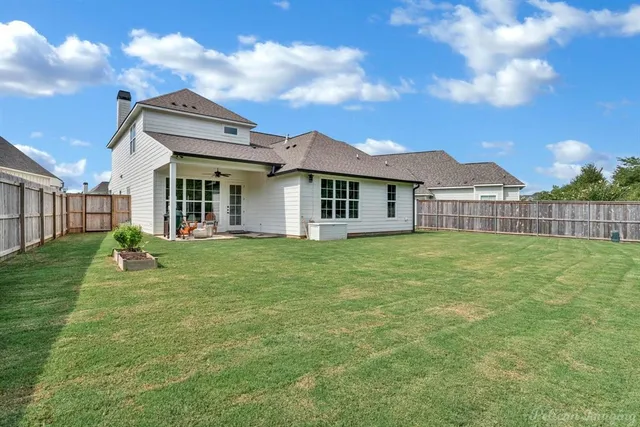 a view of a house with a backyard