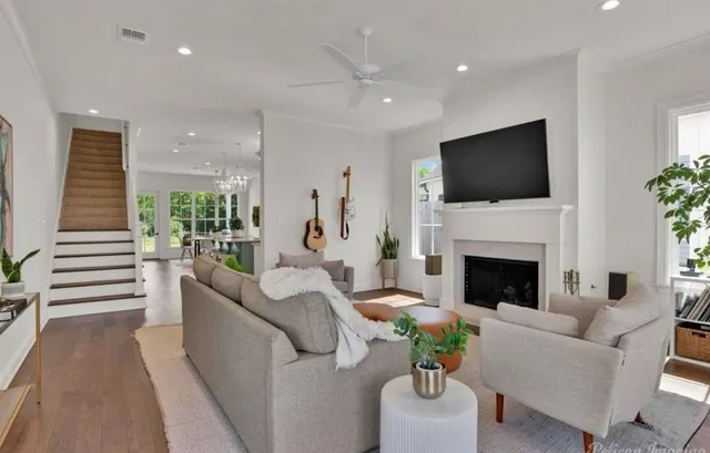 a living room with furniture a fireplace and a flat screen tv