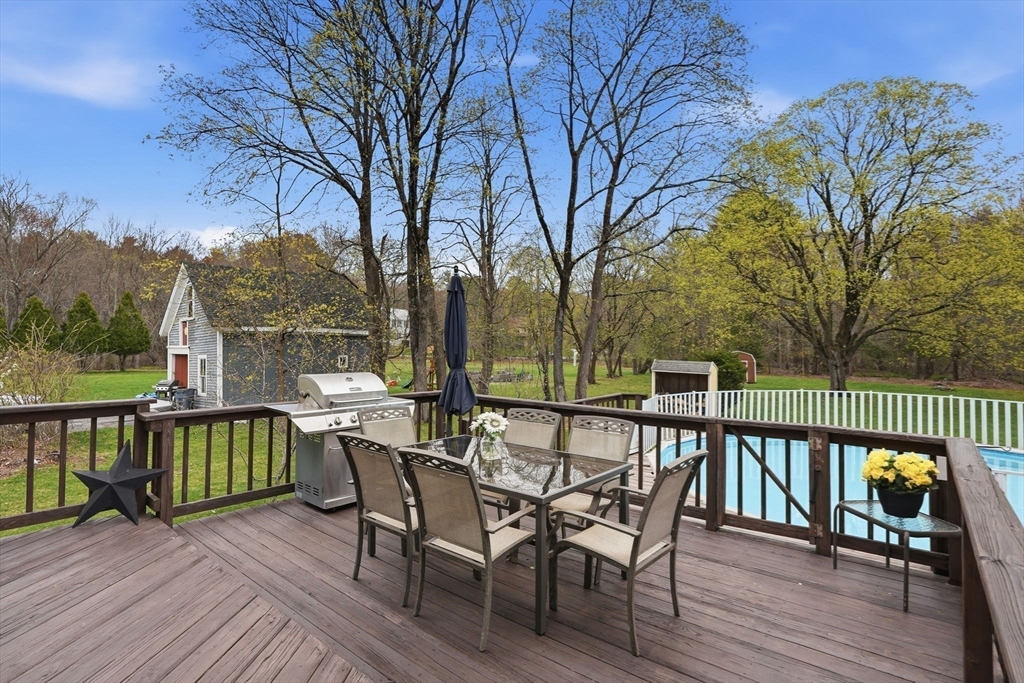 200 Branch Street Mansfield, MA 02048 - Photo 33 of 41 a view of a deck with a table and chairs next to a yard
