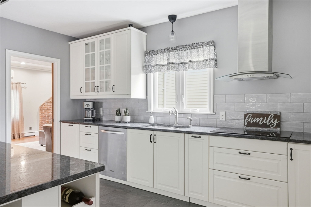 200 Branch Street Mansfield, MA 02048 - Photo 5 of 41 a kitchen with granite countertop a sink stainless steel appliances white cabinets and a window